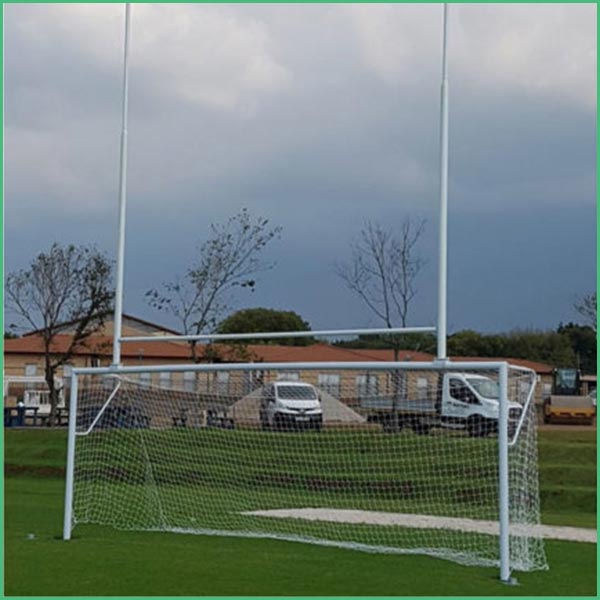 Full size soccer goal on a grassy field with a net and tall white posts