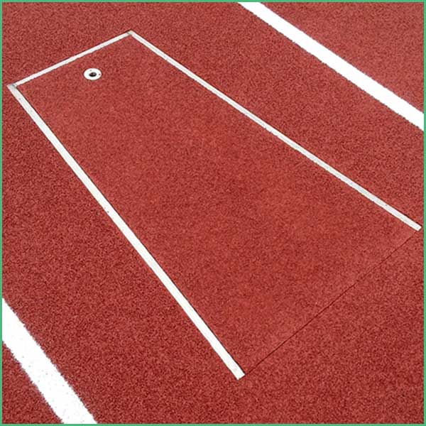 Red track surface with a white rectangular outline marking a starting box and a small circular marker nearby