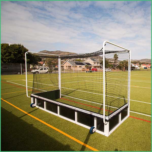 Portable soccer goal on a turf field with a net and wheels for easy transport, set against a suburban backdrop ”,“Mobile hockey/soccer goal on an outdoor field with a rectangular base and mesh net, ready for practice ”,“A wheeled, temporary soccer goal on artificial turf with a surrounding neighborhood in the background ”,“Outdoor practice goal: rectangular frame with net, mounted on a wheeled rack ”,“Soccer goal on synthetic field with movable base and netting, ready for drills ”