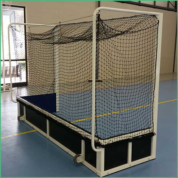 Indoor gym practice goal with white frame and black net on a blue court with yellow boundary lines