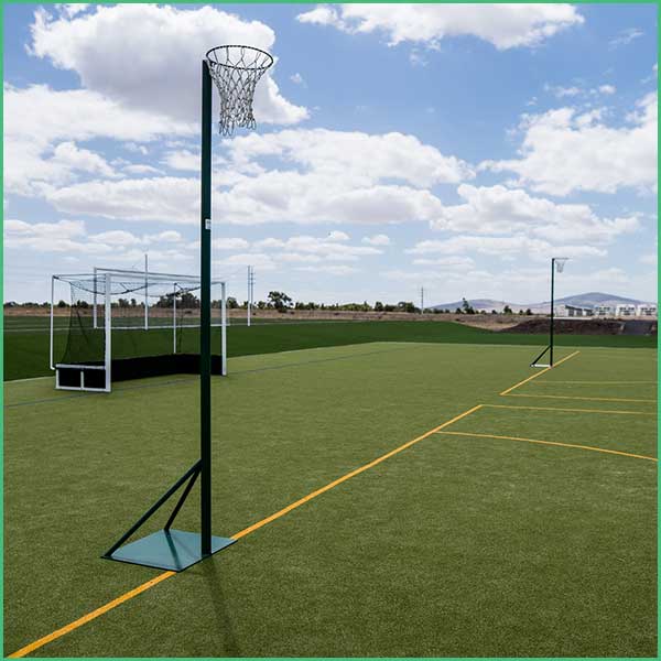 Portable indoor basketball hoop on a white stand with a blue padded sleeve reading multiple 'Emeris' logos