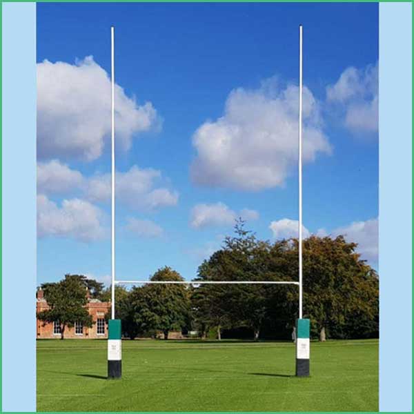 Rugby goalposts on a green field under a blue sky with white clouds