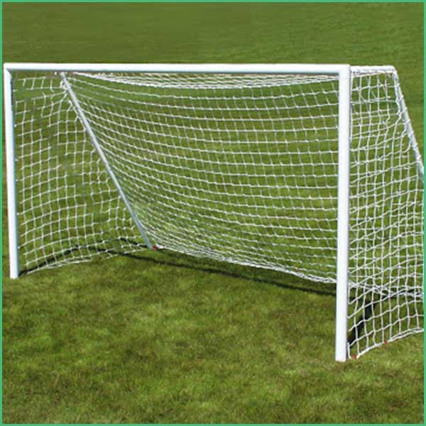 White portable soccer goal on a green grass field with netting attached 