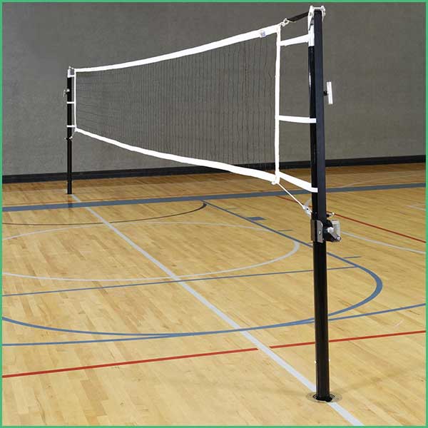 Indoor gym volleyball net set up between two black posts on a wood court with boundary lines visible