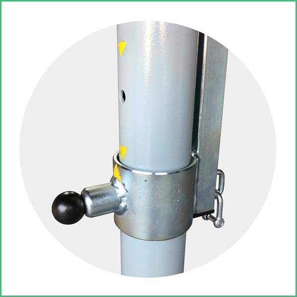 Close up of a metal post with a black knob handle and a locking collar used to adjust height