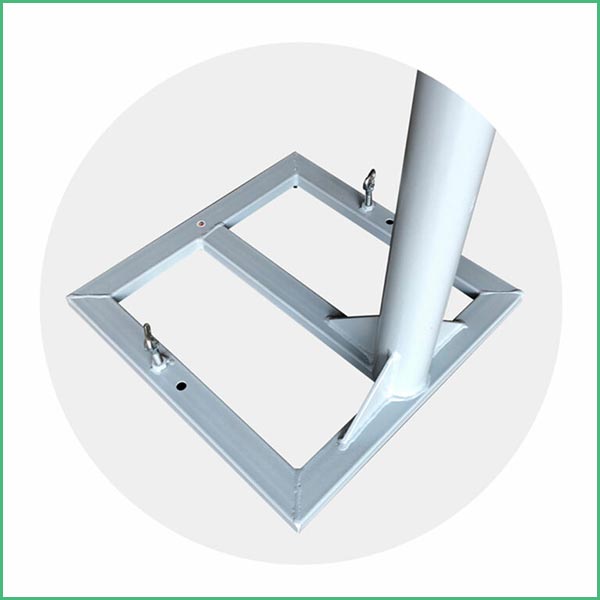 Square metal base frame with a vertical sleeve for securing a pole; shows anchor bolts and mounting points on a light gray background