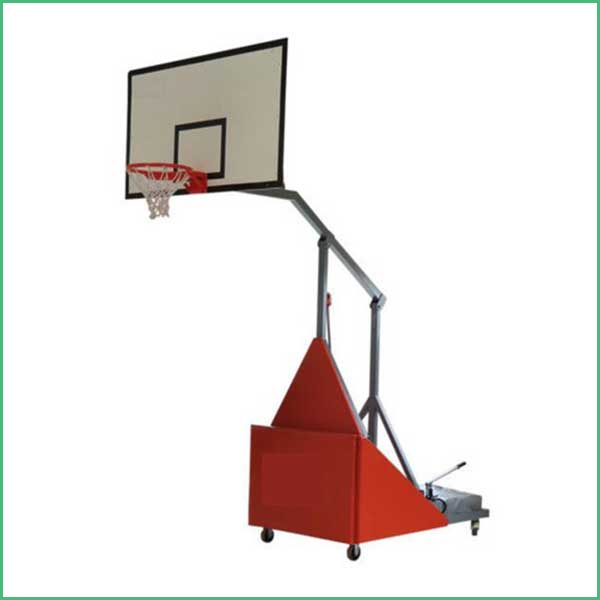 Indoor basketball gym with a portable freestanding backboard and hoop