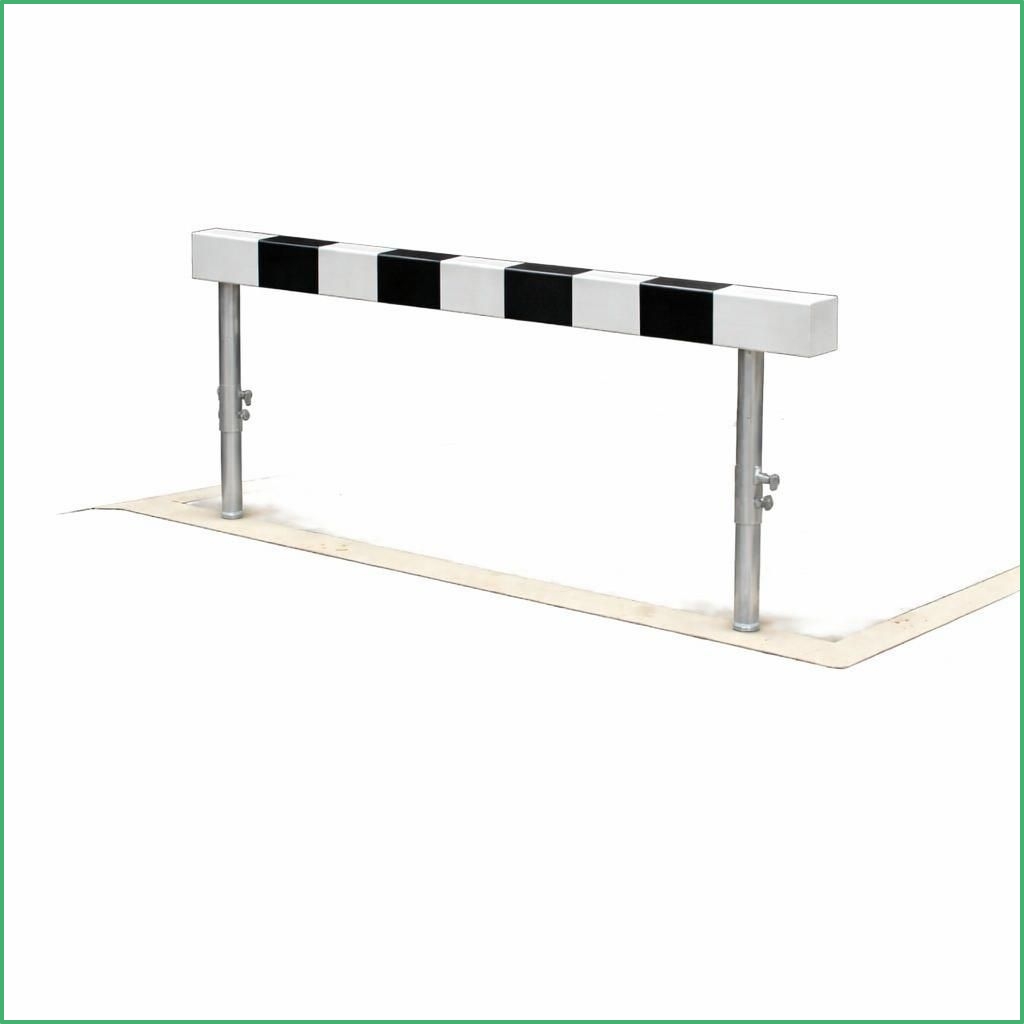 Barrier gate with a black and white striped arm on metal posts used to block vehicle access at entry points